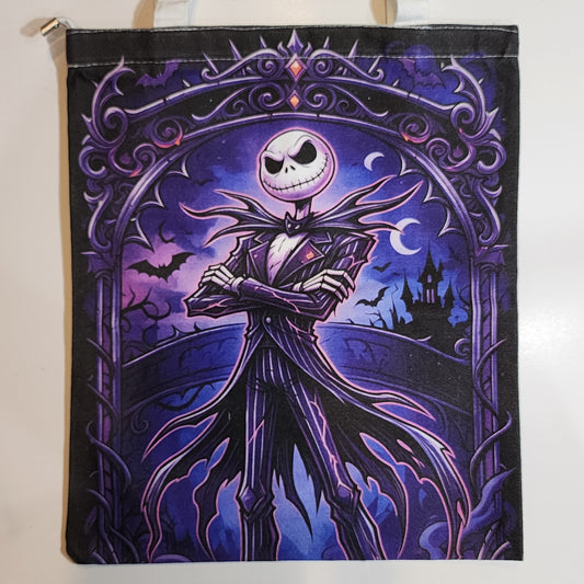 A canvas tote bag featuring a stylized illustration of Jack Skellington from The Nightmare Before Christmas, set against a dark purple gothic arch with bats, a castle, and crescent moons.